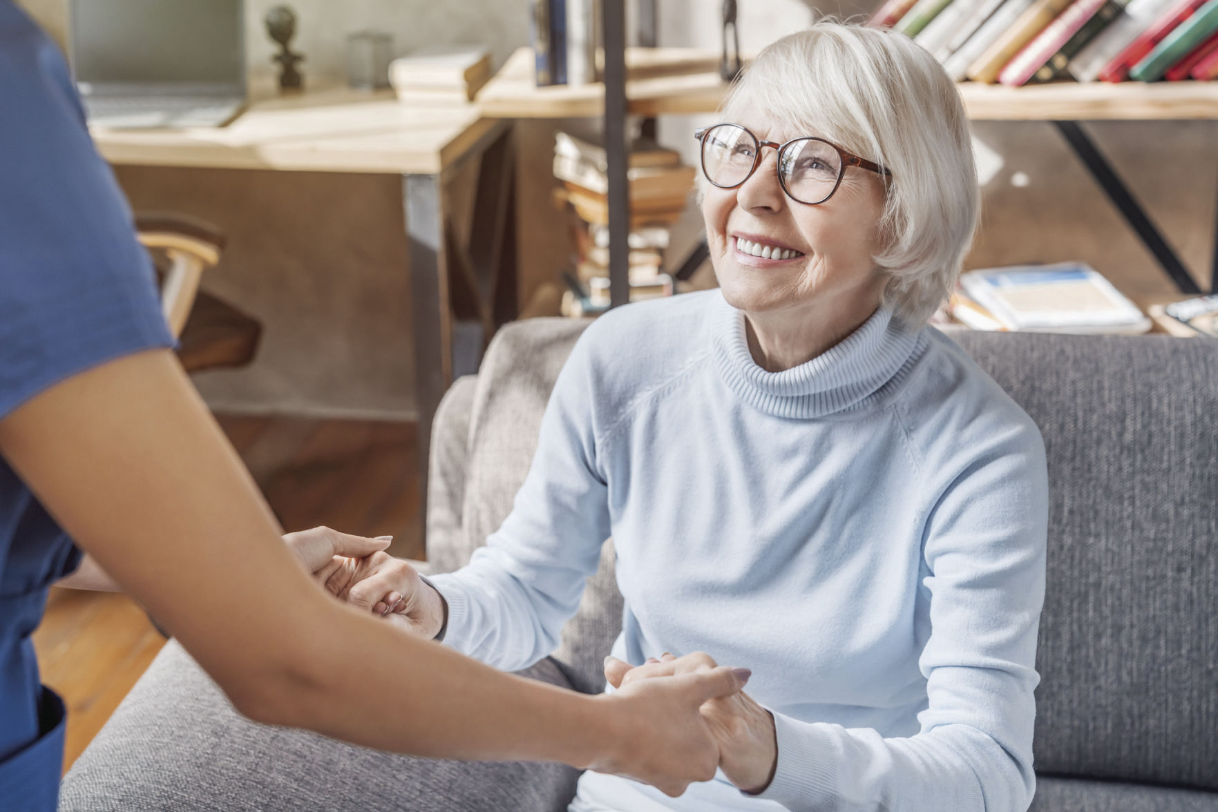 person helping elderly lady